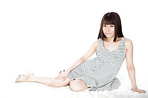 Seated wearing striped dress in high heels