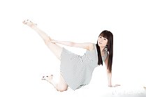 Legs stretched out wearing dress in high heels